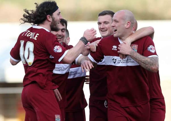 STAR MAN - Richard Cresswell is mobbed after scoring the winning goal for the Cobblers against Tranmere (Pictures: Sharon Lucey)