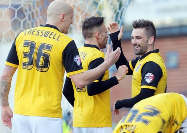 Ricky Holmes is congratulated after putting the Cobblers ahead at Bury (pictures: Kirsty Edmonds)