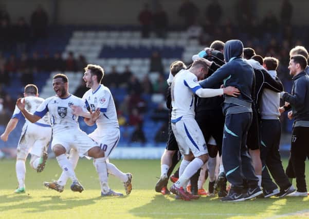 LAST-GASP WINNER - Bury's players and staff celebrate their second goal against the Cobblers (Pictures: Kirsty Edmonds)