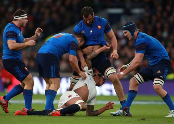 NOT HAPPY - the French players react to Courtney Lawes' crunching tackle on Jules Plisson at Twickenham on Saturday