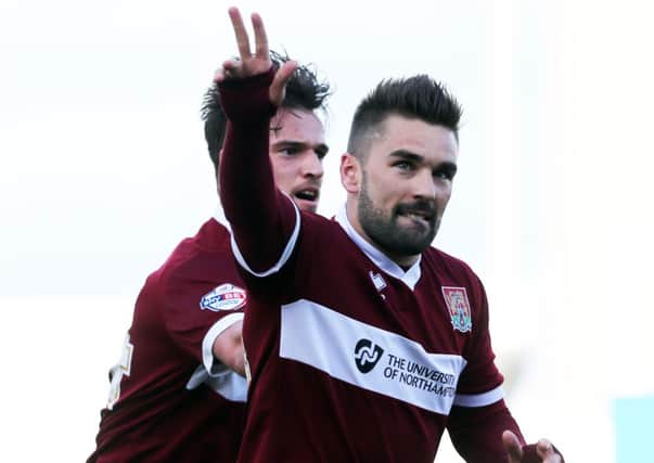 GOAL STARS - Ricky Holmes celebrates scoring the equaliser for the Cobblers with James Gray, who would later net the winner against Luton Town (Picture: Kirsty Edmonds)
