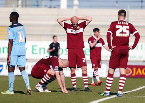 Ryan Cresswell, Jason Taylor and Joel Byrom show their dismay following the Cobblers' 1-0 defeat to Cambridge United (pictures: Kirsty Edmonds)