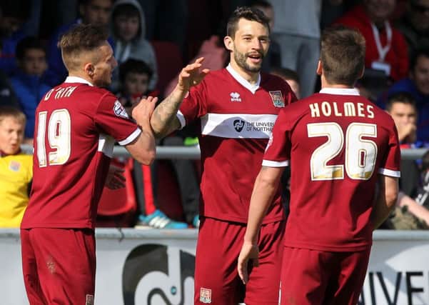 Lawson D'Ath and Ricky Holmes congratulate Marc Richards on his goal against Cheltenham (pictures: Sharon Lucey)