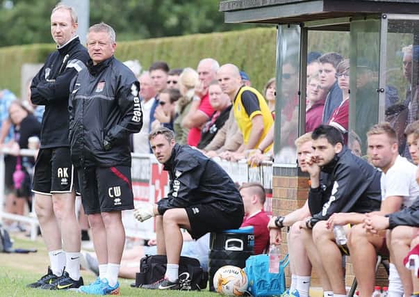 Chris Wilder and assistant boss Alan Knill watch the Cobblers in their 1-0 pre-season friendly win at Sileby (Picture: Kirsty Edmonds)