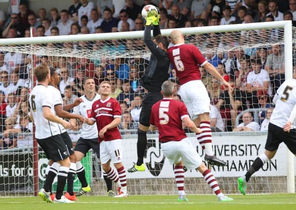 SAFE HANDS - Derby County goalkeeper Scott Carson claims a high ball under pressure from Ryan Cresswell (Picture: Sharon Lucey)