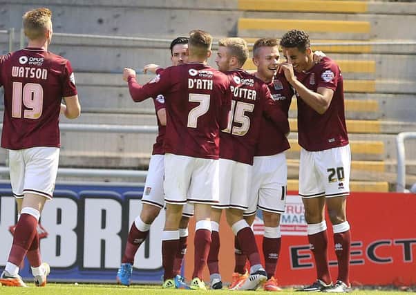 GREAT START - the Cobblers players celebrate Dominic Calvert-Lewin's early opener in the 3-2 win over Colchester United (Pictures: Kirsty Edmonds)