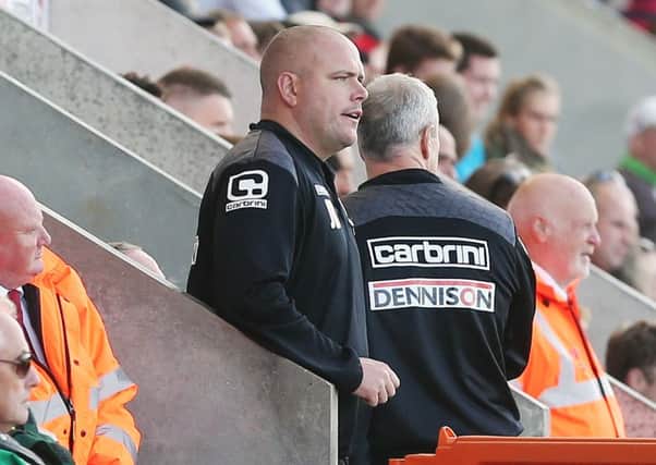 DAY TO FORGET - Jim Bentley watches his Morecambe team lose to the Cobblers (Picture: Kirsty Edmonds)
