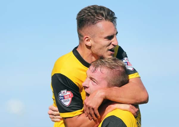GET IN THERE - Lawson D'Ath celebrates his goal with creator Nicky Adams at Morecambe on Saturday (Picture: Kirsty Edmonds)