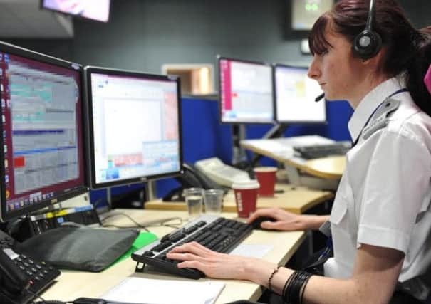 A control room operator answers calls at Northamptonshire Police headquarters. The force could soon introduce a voice recognition tool to its 101 service.
