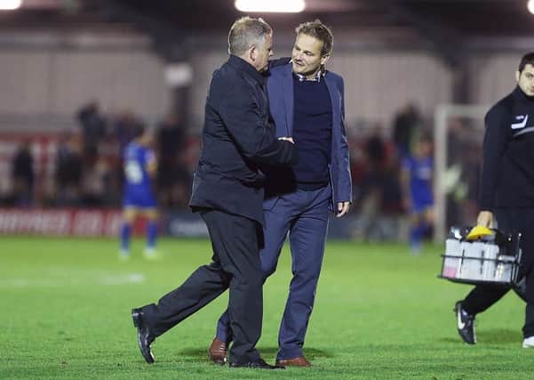 HONOURS EVEN - Chris Wilder shakes hands with AFC Wimbledon counterpart Neal Ardley at the end of the 1-1 draw at Kingsmeadow on Tuesday (Pictures: Kirsty Edmonds)