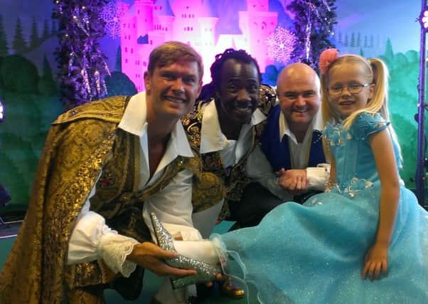 Pantomime stars John Partridge, Sid Sloane and Danny Posthill meet one of their fans at the launch of Cinderella coming to the Royal and Derngate.