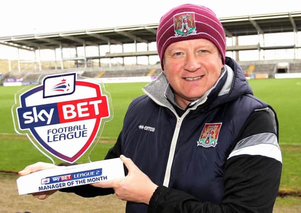 ALL SMILES - Cobblers boss Chris Wilder shows off his Sky Bet League Two manager of the month award at Sixfields