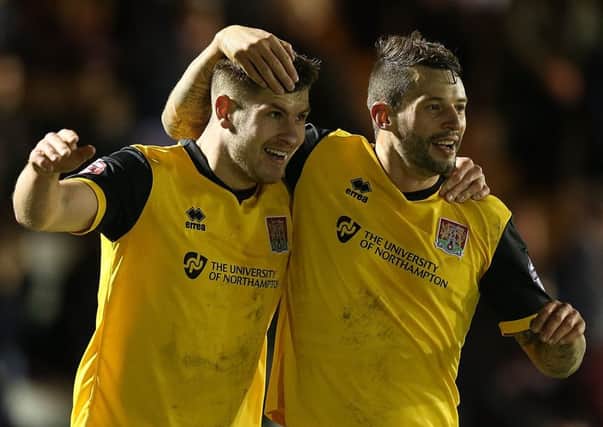 GREAT START - James Collins (left) celebrates with Marc Richards after scoring his first goal for the Cobblers at Plymouth on Tuesday (Picture: Pete Norton)