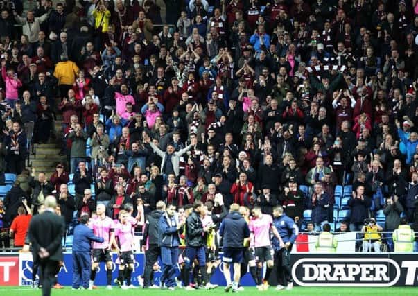 The Cobblers fans and players celebrate the FA Cup first-round win at Coventry City