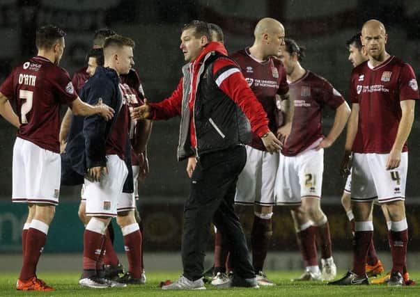 Milton Keynes boss Karl Robinson shakes hands with the Cobblers players following the 2-2 draw at Sixfields