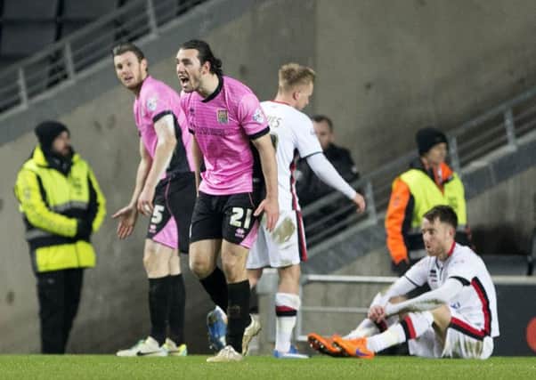 DEAF EARS - Zander Diamond and John-Joe O'Toole make their complaints after the award of the first penalty against the Cobblers at MK Dons on Tuesday (Pictures: Kirsty Edmonds)