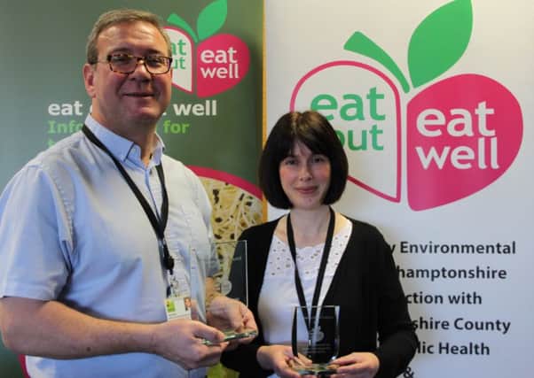 Senior Environmental Health Officer Des Hillier and Community Projects Officer Sally Johnson with the trophies.