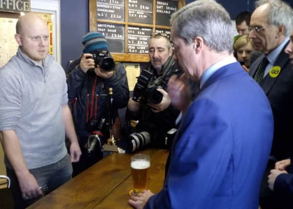 Farage has a pint in The Little Ale House. NNL-160123-175318001