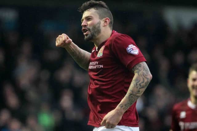 Cobblers skipper Marc Richards punches the air in delight after putting his side 2-0 ahead (pictures by Sharon Lucey)