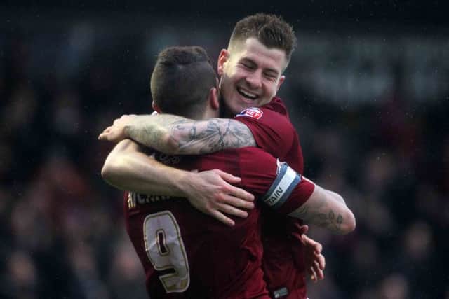 James Collins and Marc Richards celebrate after Cobblers double their lead