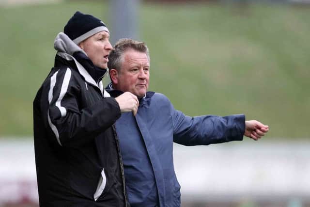 Chris Wilder and Alan Knill in discussion at a wind-swept Sixfields on Saturday (pictures by Sharon Lucey)