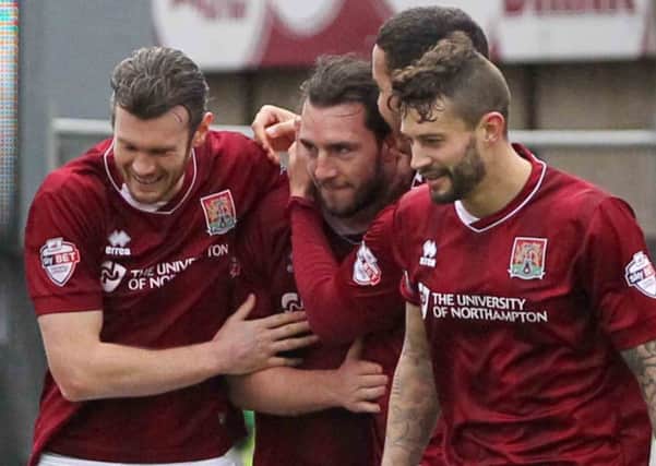 PLENTY OF EXPERIENCE - Cobblers boss Chris Wilder says the squad, captained by Marc Richards (above, right) are policing themselves