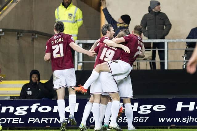 Ecstasy: Cobblers celebrate after Marc Richards' penalty gives them the lead at Oxford (pictures by Kirsty Edmonds)