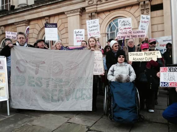 Members of the public, union members and service users protested against the planned Â£65m worth of cuts to the county council outside County Hall yesterday.