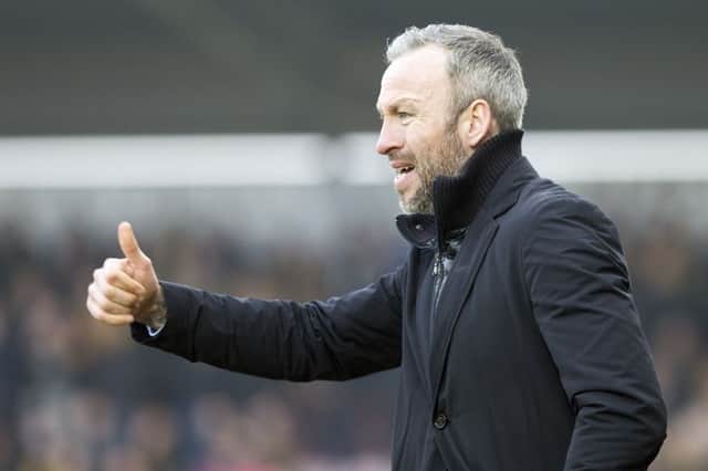 Thumbs-up: Shaun Derry was "proud" of his side's display at Sixfields (picture by Kirsty Edmonds)