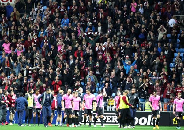 IN IT TOGETHER - the Cobblers players and supporters enjoy the FA Cup win at Coventry City in November, when the future of the club was in serious doubt