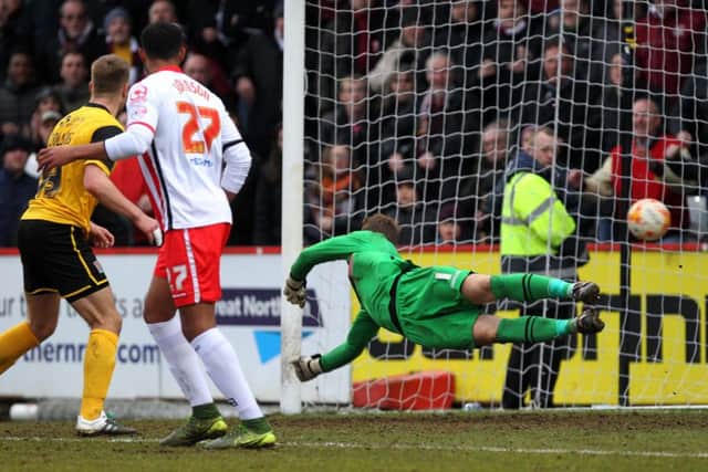 LAST-GASP: Jamie Jones is left grasping at thin air as Ricky Holmes smashes home the winner (pictures by Sharon Lucey)