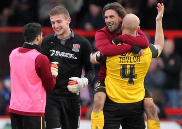 GET IN THERE! - Danny Rose, Adam Smith, Ricky Holmes and Jason Taylor celebrate the Cobblers' stunning win at Stevenage on Saturday (Picture: Sharon Lucey)