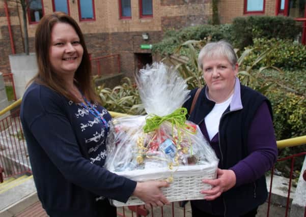 Community projects officer Emma Parry presents the hamper to prize draw winner Beverley Higham