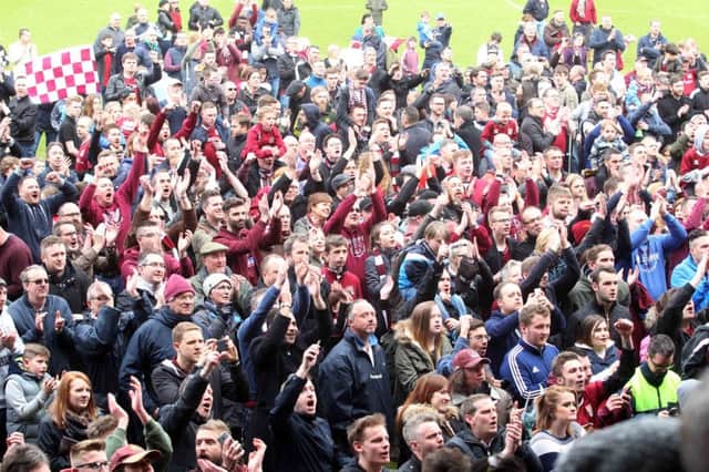 GOING UP! - the Cobblers supporters enjoy their team's promotion following their 2-2 draw with Bristol Rovers (Pictures: Sharon Lucey)