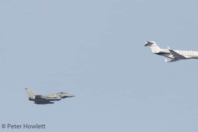 The Challenger 300 D-BTLT private plane is escorted by the two Typhoon jets into Cardiff. Photo by Peter Howlett.