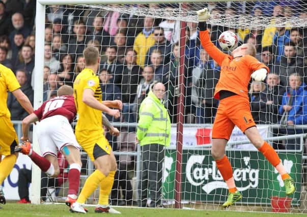 GET IN THERE - Nicky Adams heads in the Cobblers' opener in the 2-2 draw with Bristol Rovers on Saturday, and then (below) celebrates (Pictures: Sharon Lucey)