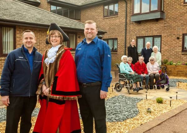 In the foreground, (pictured left to right) Brian Revers, Warehouse Planner at Tesco, the Mayor of Daventry Cllr Wendy Randall and Steve Boatman, Warehouse Planner at Tesco. Iin the background are Daventry & District Housing Community Development Officer, Sarah Sims and Warwick Court residents and keen gardeners George and Fran Broomhall.