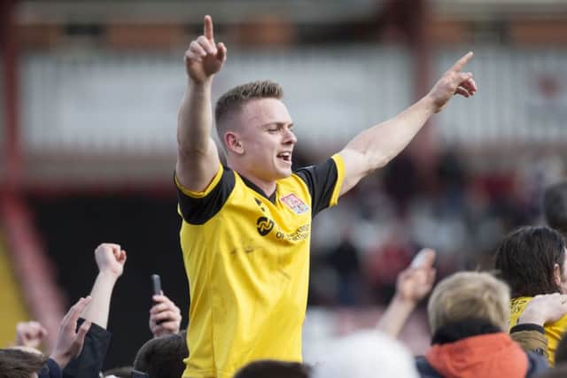 CELEBRATION TIME: Cobblers players and fans kick-start the title celebrations (pictures by Kirsty Edmonds)