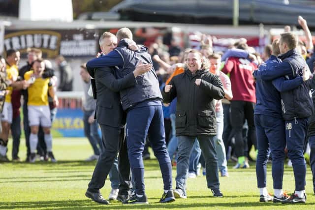 Chris Wilder and Alan Knill share a hug