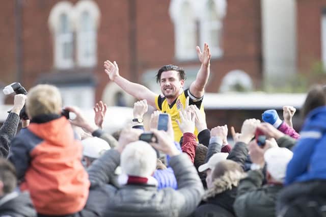 ALL HAIL BUCHS: David Buchanan celebrates after Cobblers clinch the title. Pictures: Kirsty Edmonds