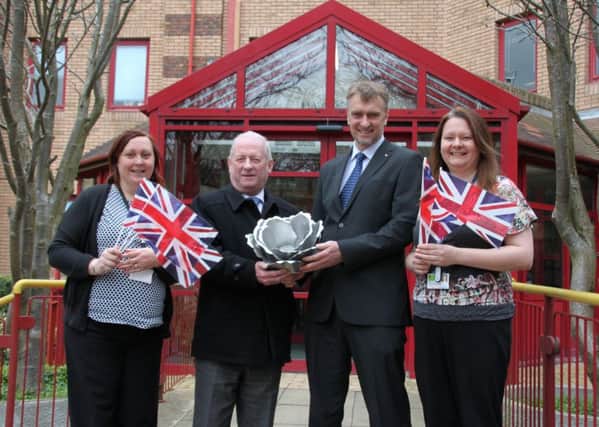 From left, DDC Community Projects Officer Gemma Mason, Chief Executive Ian Vincent, Deputy Chief Executive Simon Bovey and Community Projects Officer Emma Parry with the metal rose which will form the top of the official beacon.
