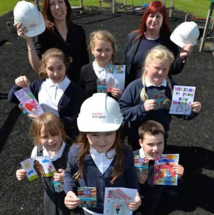 Woodford Halse CofE Primary Academy Representative, Jo Usher (left) and Taylor Wimpey Sales Executive, Trudy World (right) with the pupils and their winning entries.