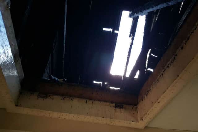 The lightening caused the television set in the living room to catch fire