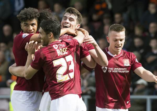 HAPPY LADS - the Cobblers players celebrate John Marquis's goal in the win over Luton (Pictures: Kirsty Edmonds)