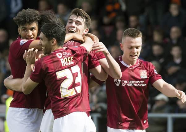 FULLY COMMITTED - the Cobblers players celebrate John Marquis's goal in last Saturday's 2-0 win over Luton Town
