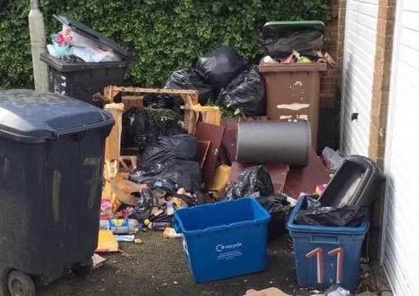 Rubbish dumped by garages on the estate