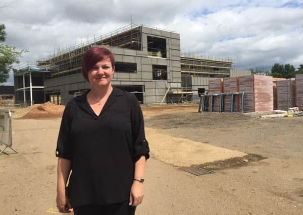Jo Davies outside the new building under construction in Daventry