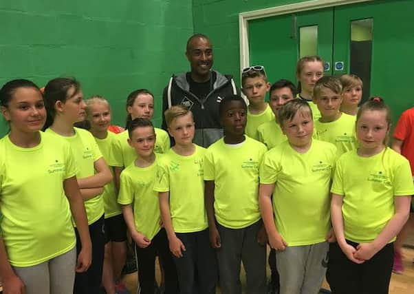 Colin Jackson with pupils from Abbey Academy.