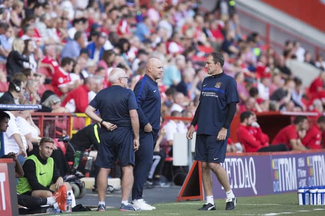 Rob Page and assistant Paul Wilkinson discuss their options during Northampton's clash with Charlton at the Valley. Picture: Kirsty Edmonds