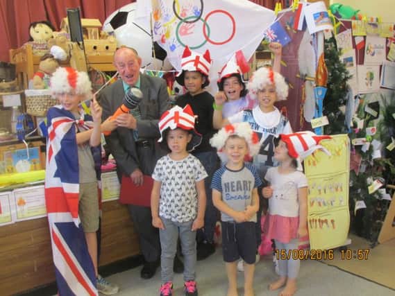 Children, staff, and Cllr Alan Hills at Happy Faces summer play scheme.